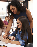 teacher helping student in classroom