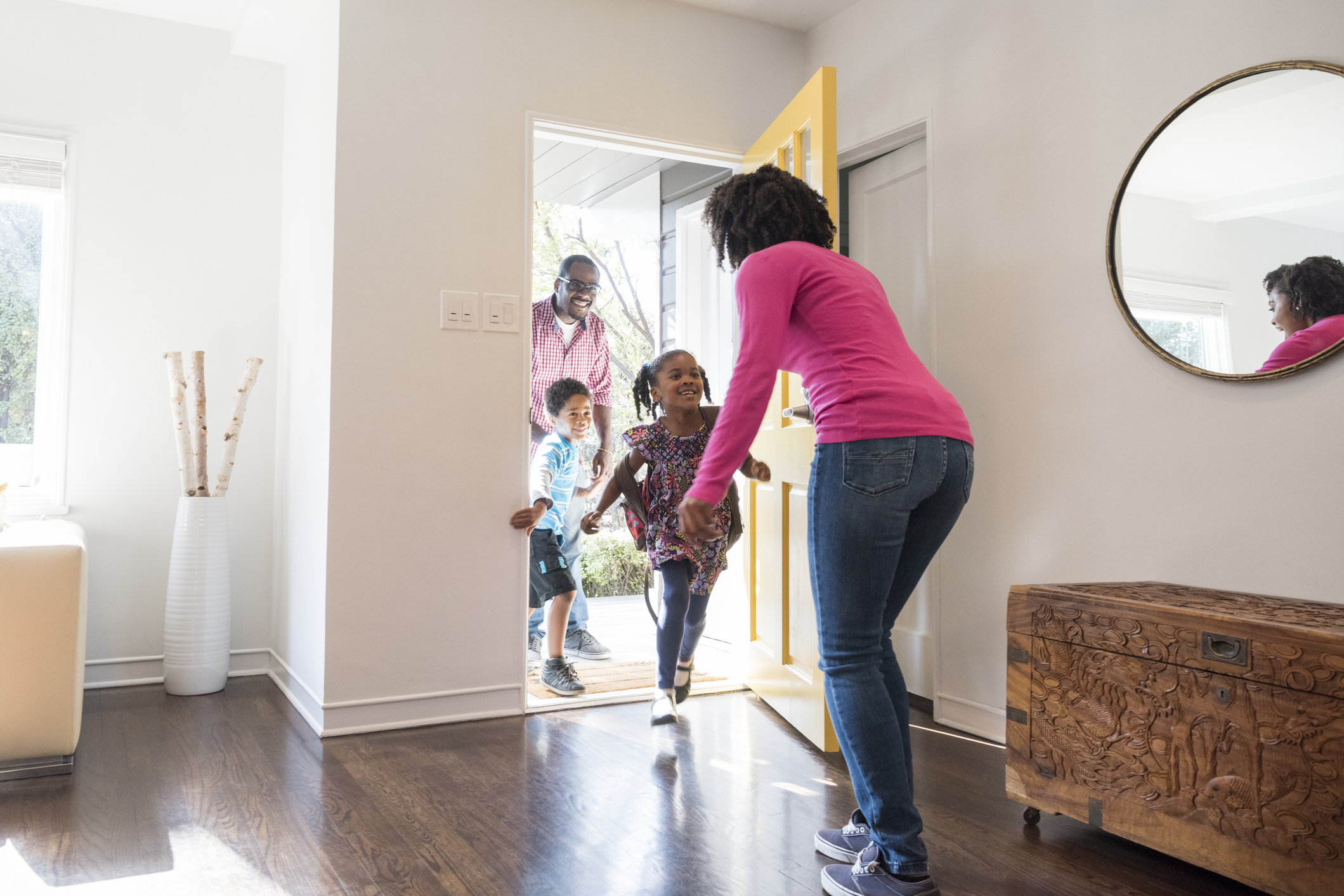 kids running through front door of home