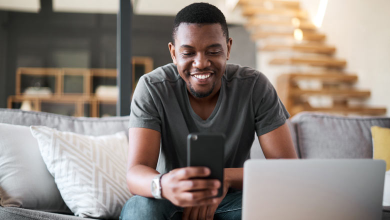 man on couch with phone