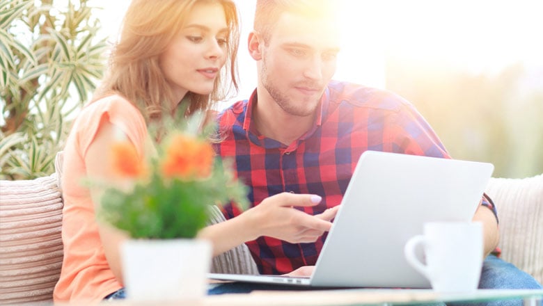 Couple on patio viewing laptop