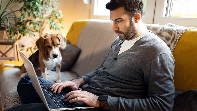 man on couch with his dog