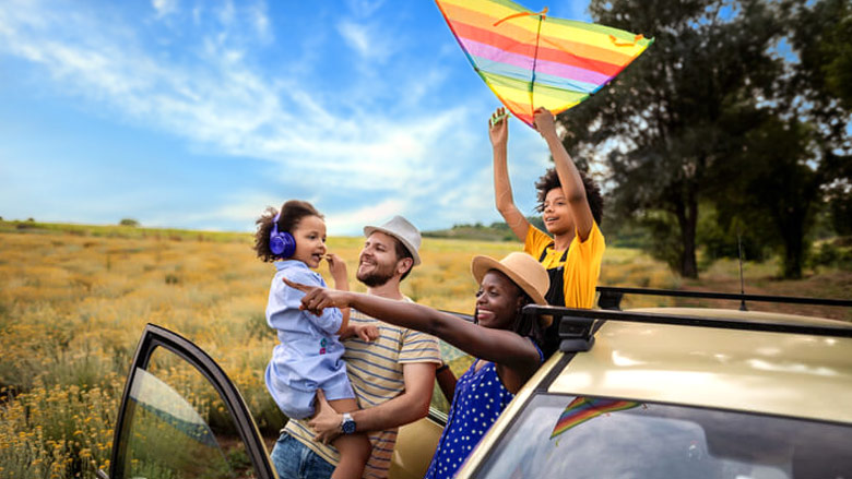 Family with a kite getting out of the car together