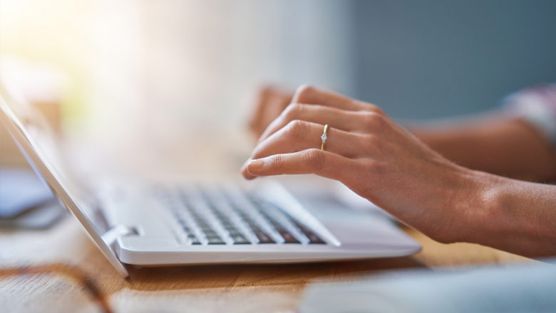 Woman's hands typing at computer