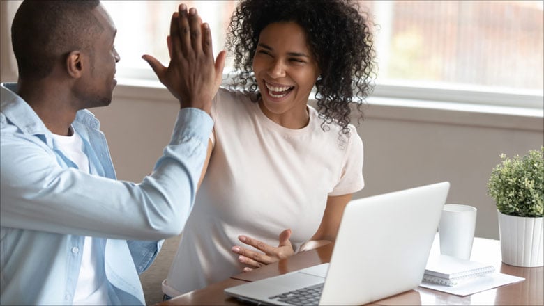 Couple High Five at Laptop