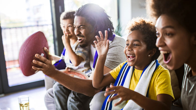 Family enjoying a football game on TV