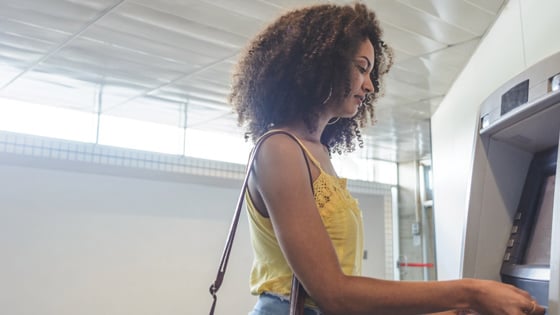 Woman accessing student account at an ATM