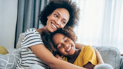 African American mom and daughter on couch