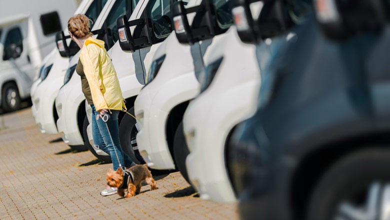 Woman with a dog, looking at RV’s