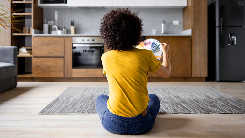 Young woman deciding what color her kitchen should