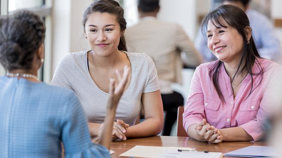 three women at table talking